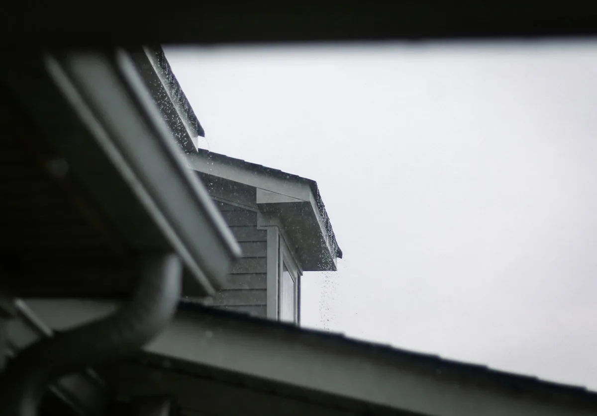Seamless gutter run carrying rain along a roofline