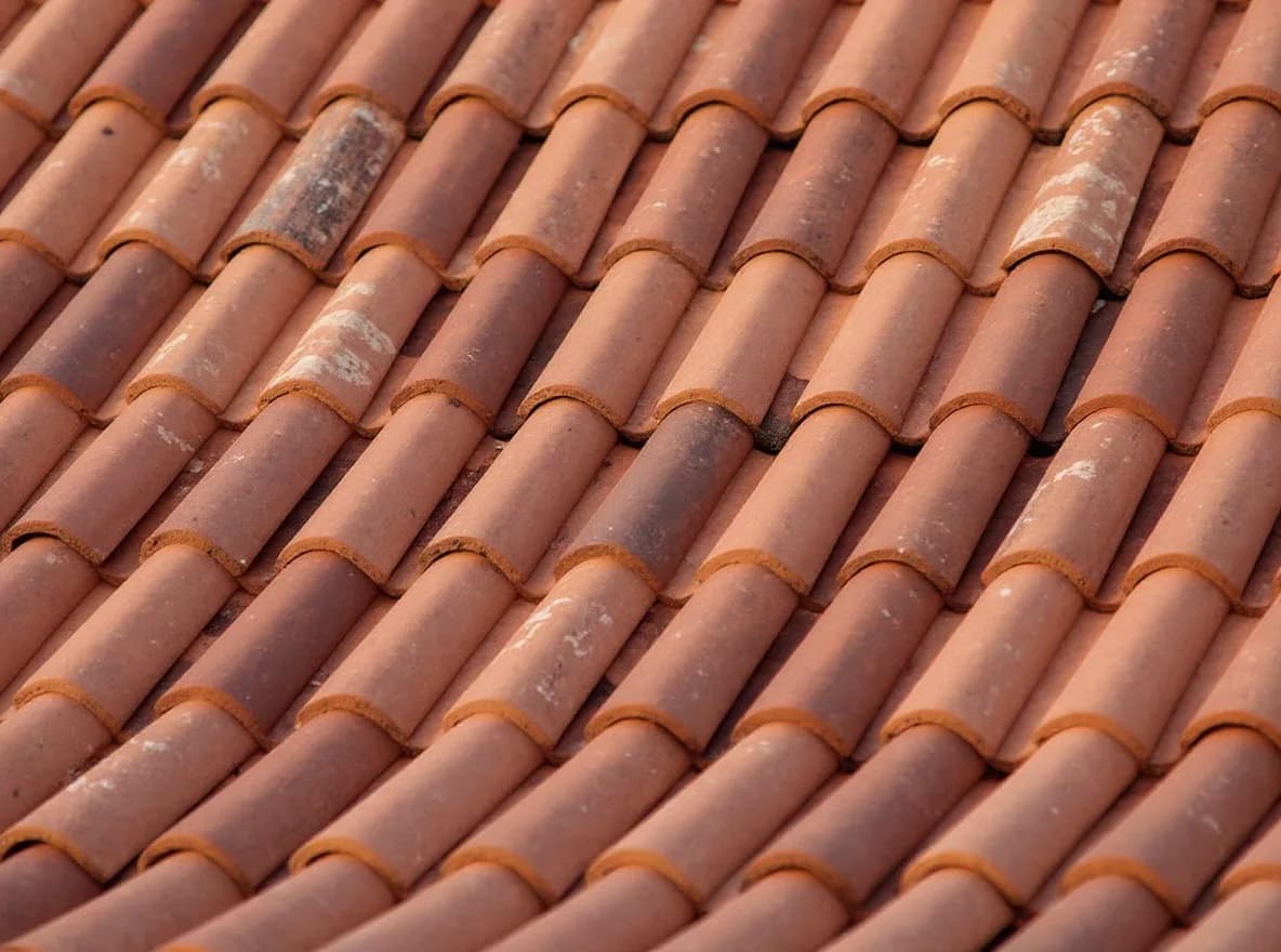 Restored terracotta tile roof with a rebuilt dormer